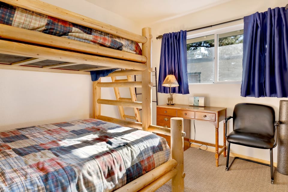 Peaceful cabin bedroom with plush bedding, and beautiful views—ideal for restful nights, cozy mornings, and a relaxing mountain escape.