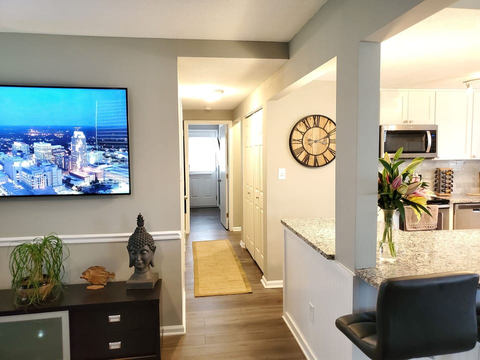 washer and dryer located in hallway, leads directly towards the backyard.
