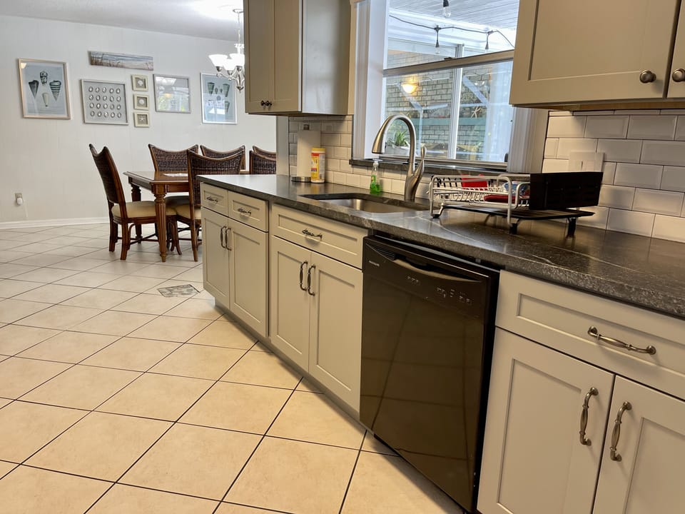 Well appointed kitchen with dishwasher and granite countertops.