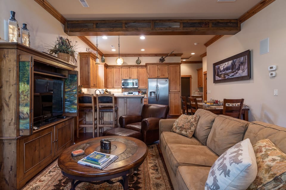 There is a cozy couch and two chairs situated to enjoy the ambiance of the fireplace.