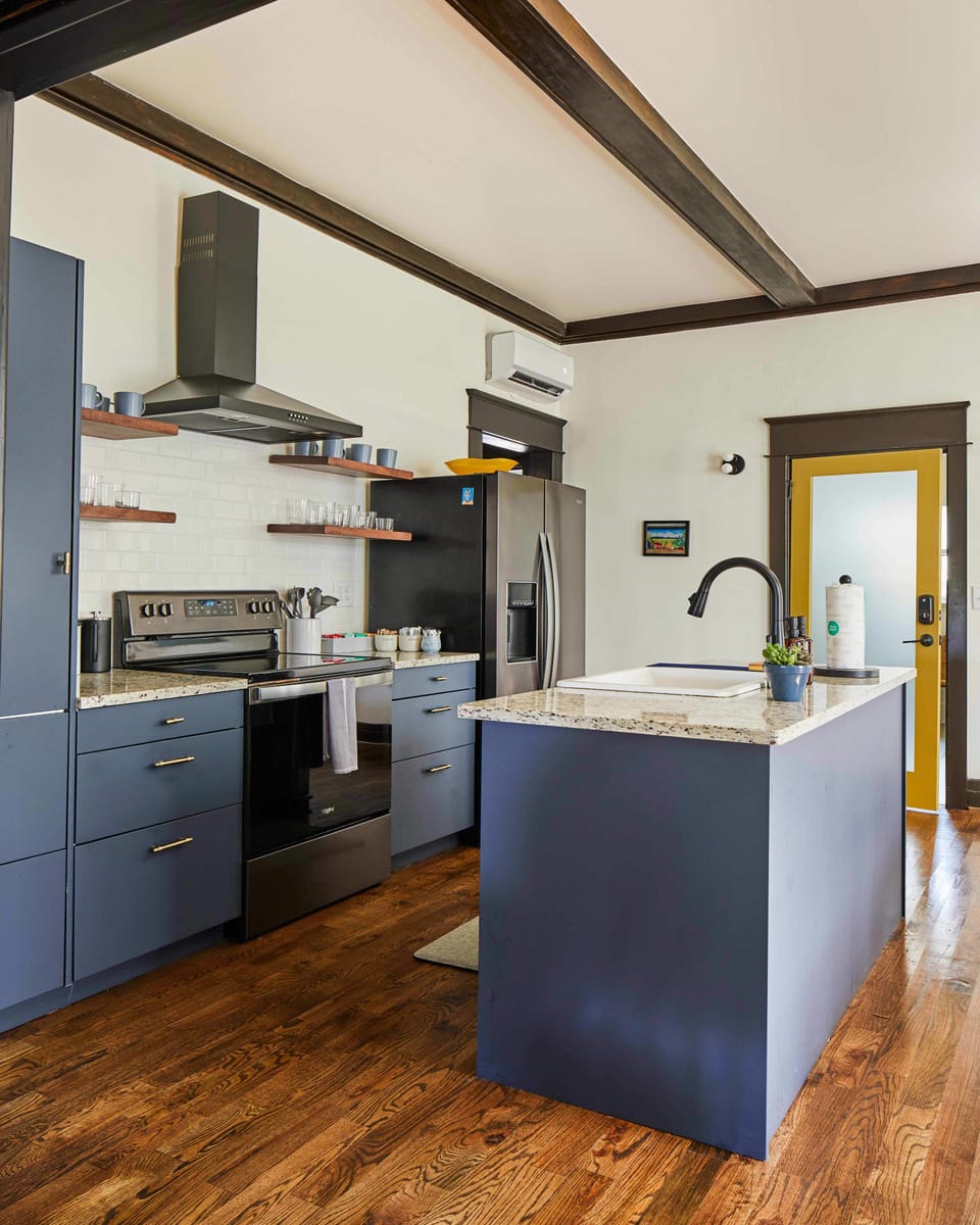From the living room, step through the original pocket doors into the airy and modern kitchen. You'll love cooking in this sleek, efficient space.
