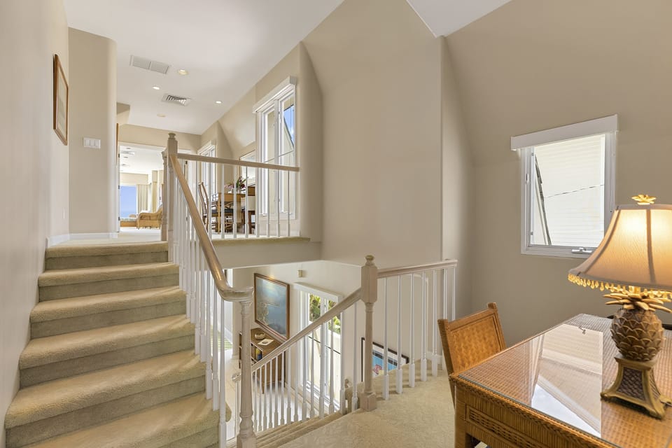 Elegant staircase leads to oceanview suites and upper-level privacy.