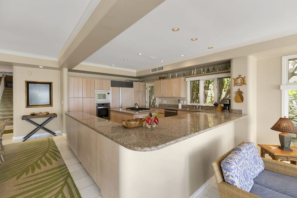 Open-concept kitchen with bar seating, ideal for entertaining or casual breakfasts.