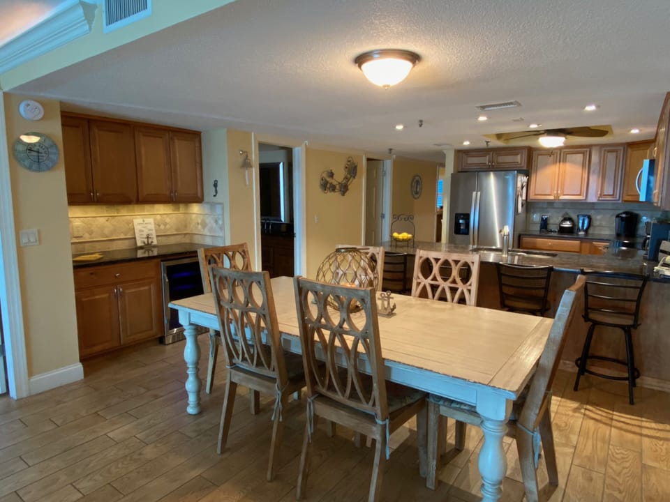 Dining table seating for 6 and 4 additional stools at the kitchen counter.