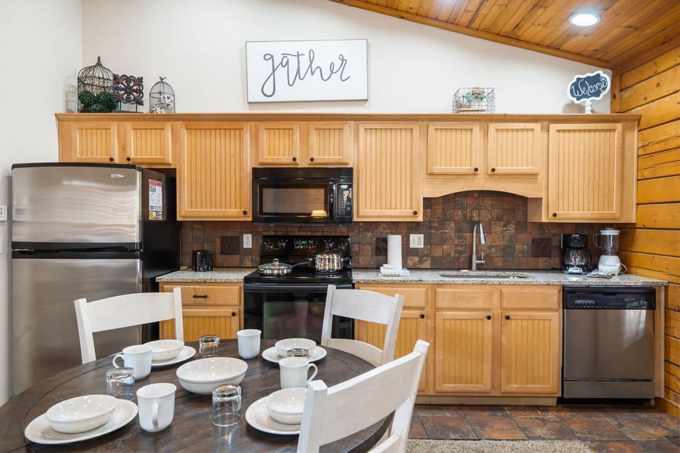Charming kitchen with full-size appliances, granite countertops, and a cozy dining area—perfect for gathering and sharing meals.
