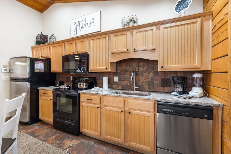 Charming kitchen featuring full-size appliances, granite countertops