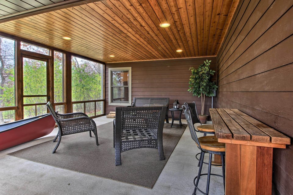 Seating Area in Screened-In Porch with Canoe for Guest Use