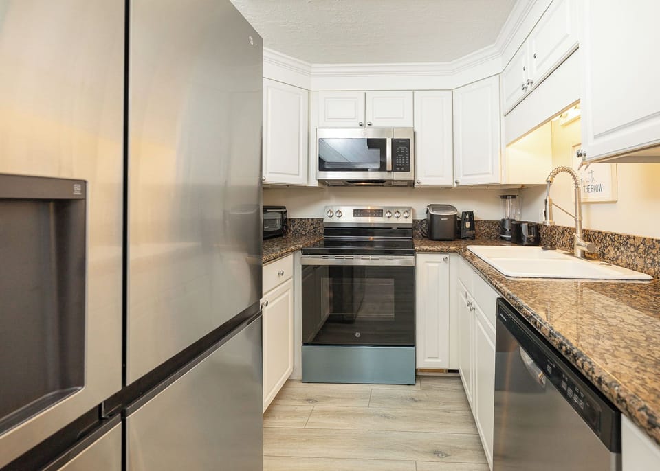 Craft delightful family meals in this kitchen, with sleek appliances and inviting counter space ready for your creations