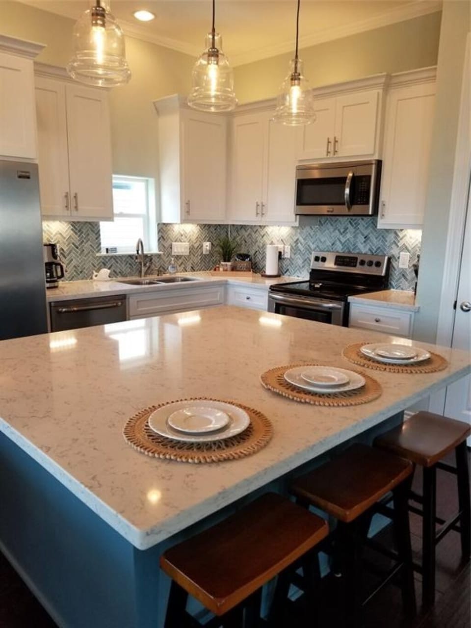Huge Island in kitchen / easily sits 3, with storage underneath.