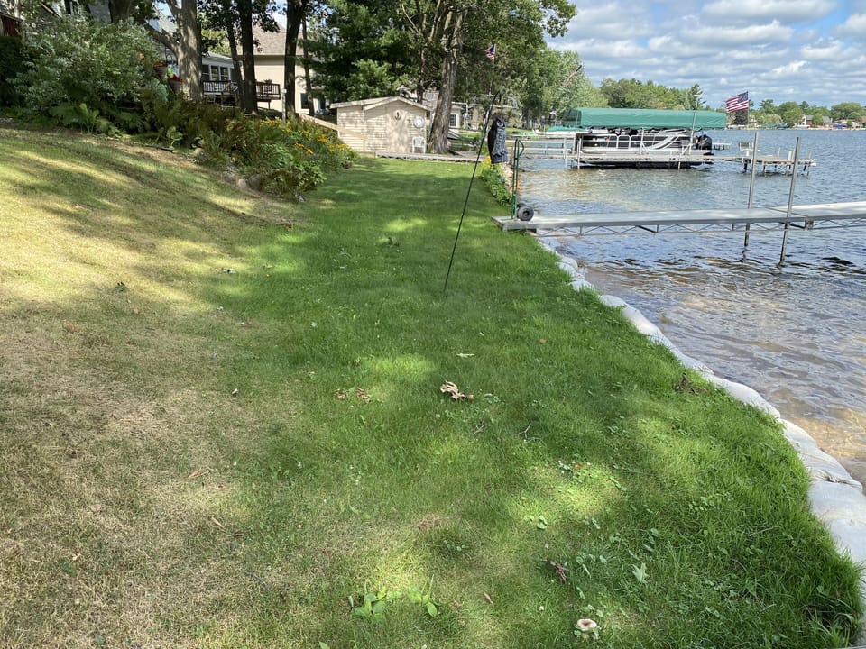 Shady grass area for relaxing, beach as of 2021, much more sandy beach in 2024