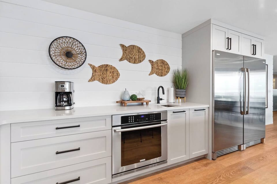 Full sized fridge and freezer along with a utility sink and second oven