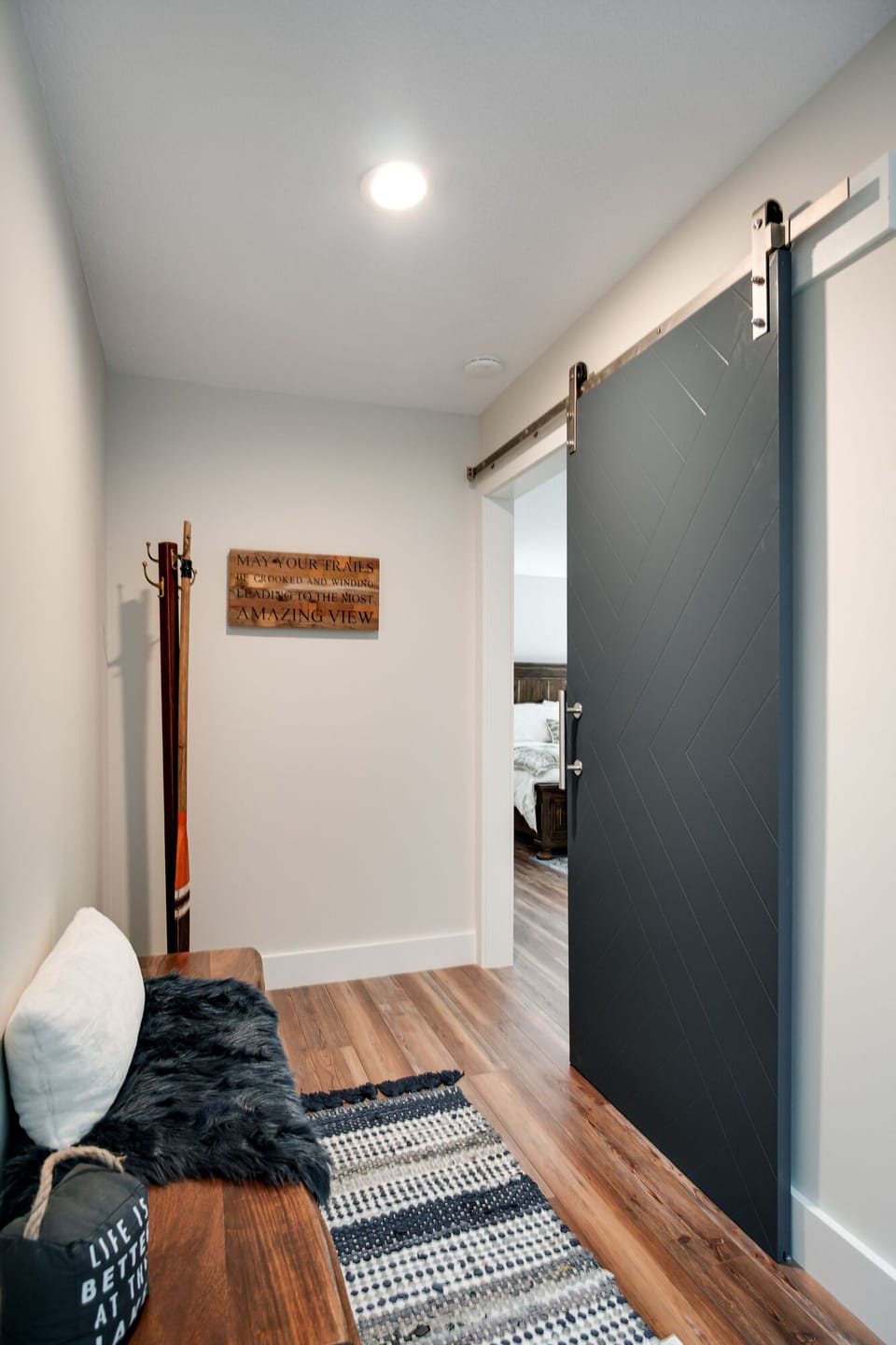Entry hall with gorgeous blue chevron barn door.