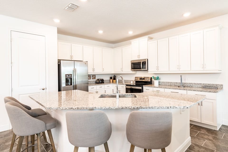 Fully stocked kitchen with indoor and outdoor dishes, utensils, and more