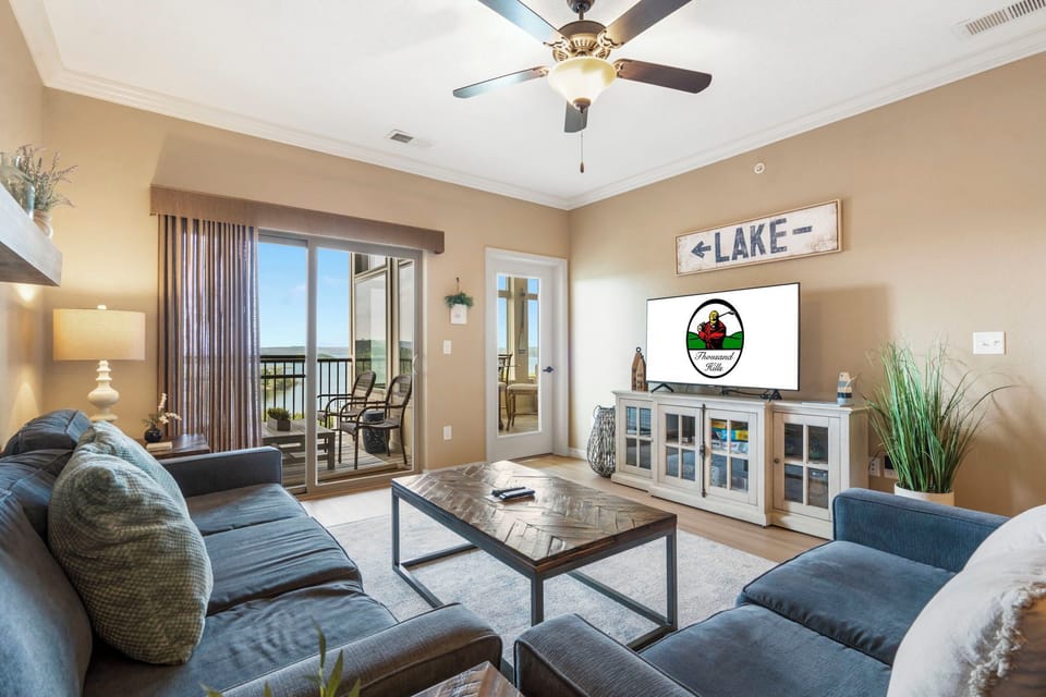 Living space featuring cable TV, a queen sleeper sofa, and access to a deck and sunroom.