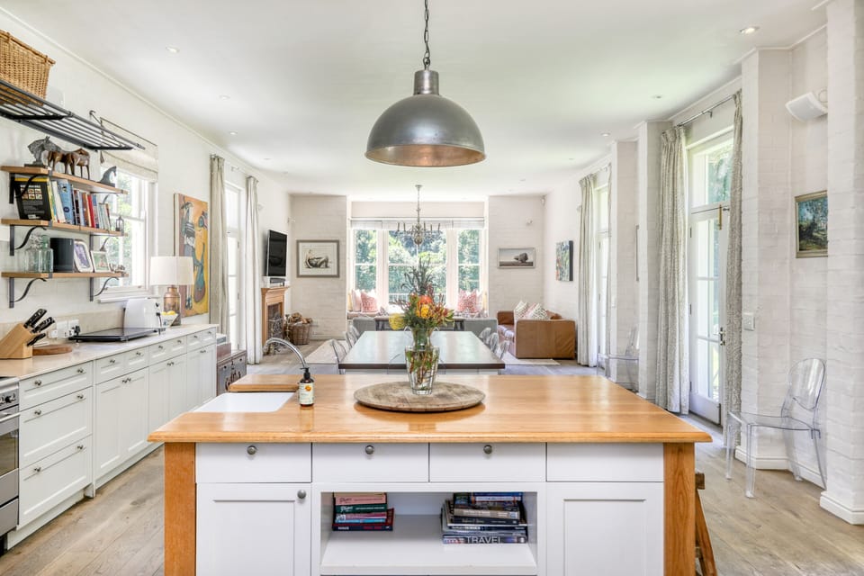 Open plan kitchen into dining and living areas.