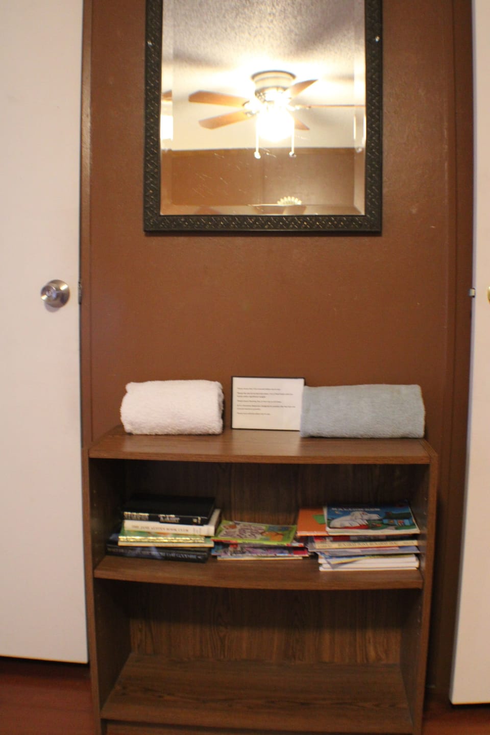 Book shelf, which includes children's books, is located in bedroom #3