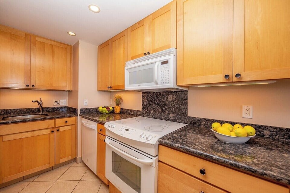 Bright kitchen with full appliances, perfect for cooking meals at home.