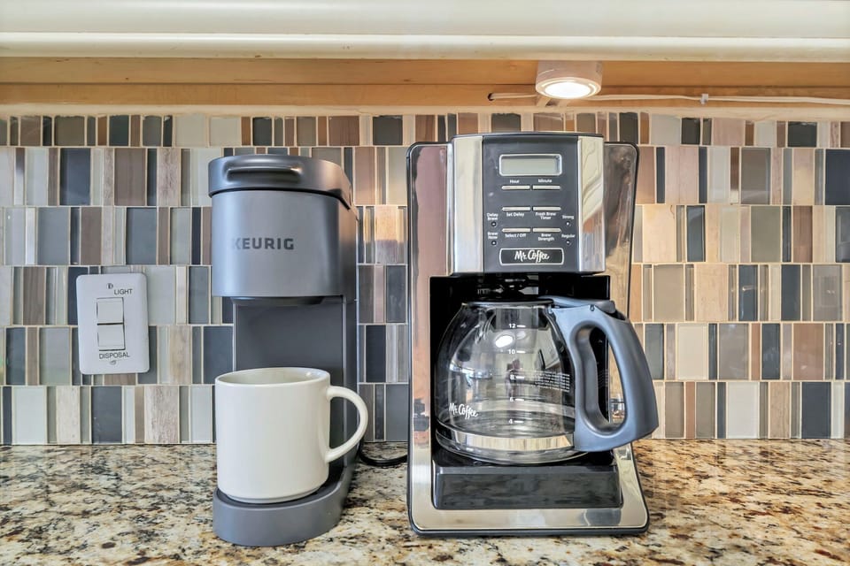 Start your mornings right with your personal coffee station, featuring both Keurig and traditional brewing options for the perfect cup.