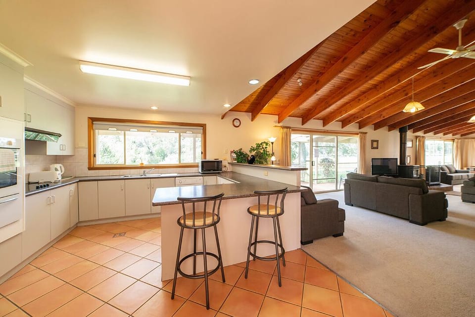Modern kitchen for culinary adventures and dining comfort.