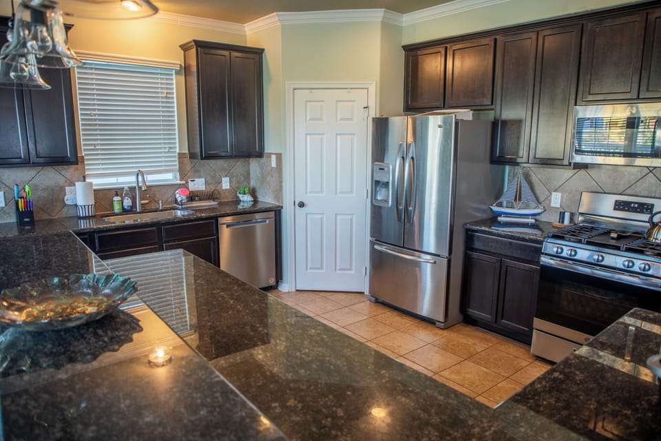 Kitchen area. Pantry. Stove. Fridge with ice maker. Dishwasher. 