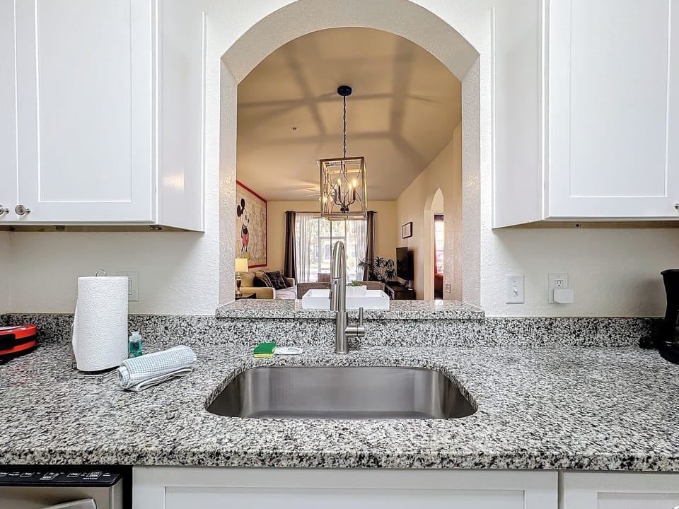 Serve snacks at the breakfast bar that opens into the kitchen.