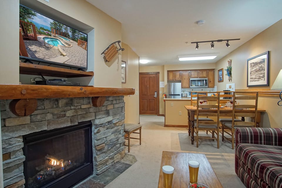 View from the patio of the gas fireplace, dining area and kitchen