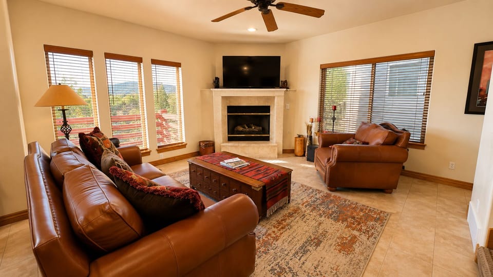 Gather with family and friends in this comfortable living space featuring abundant natural light, plush seating, and a cozy fireplace.