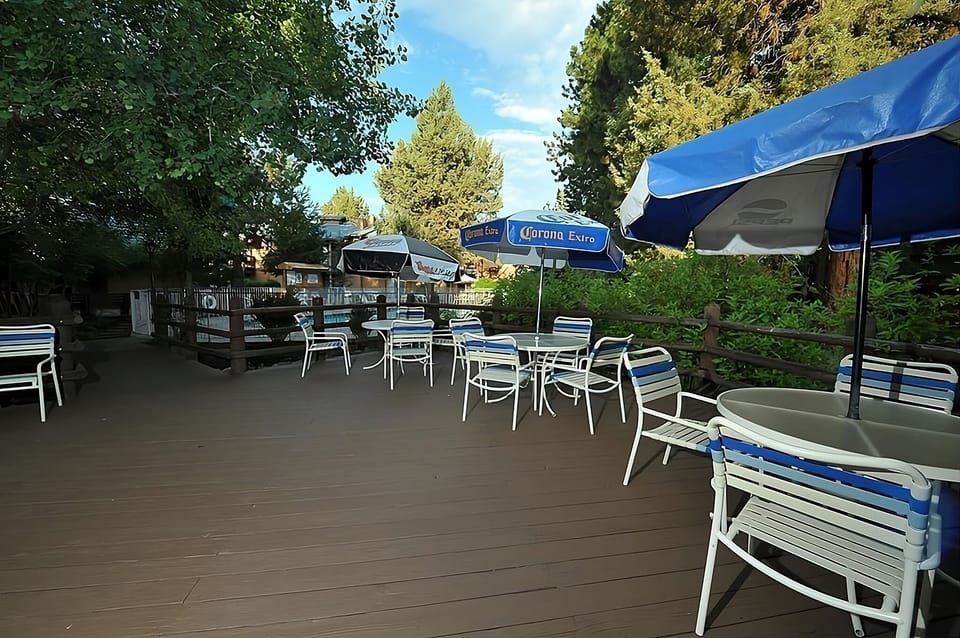 Gather outdoors for drinks and conversation under shaded umbrellas.