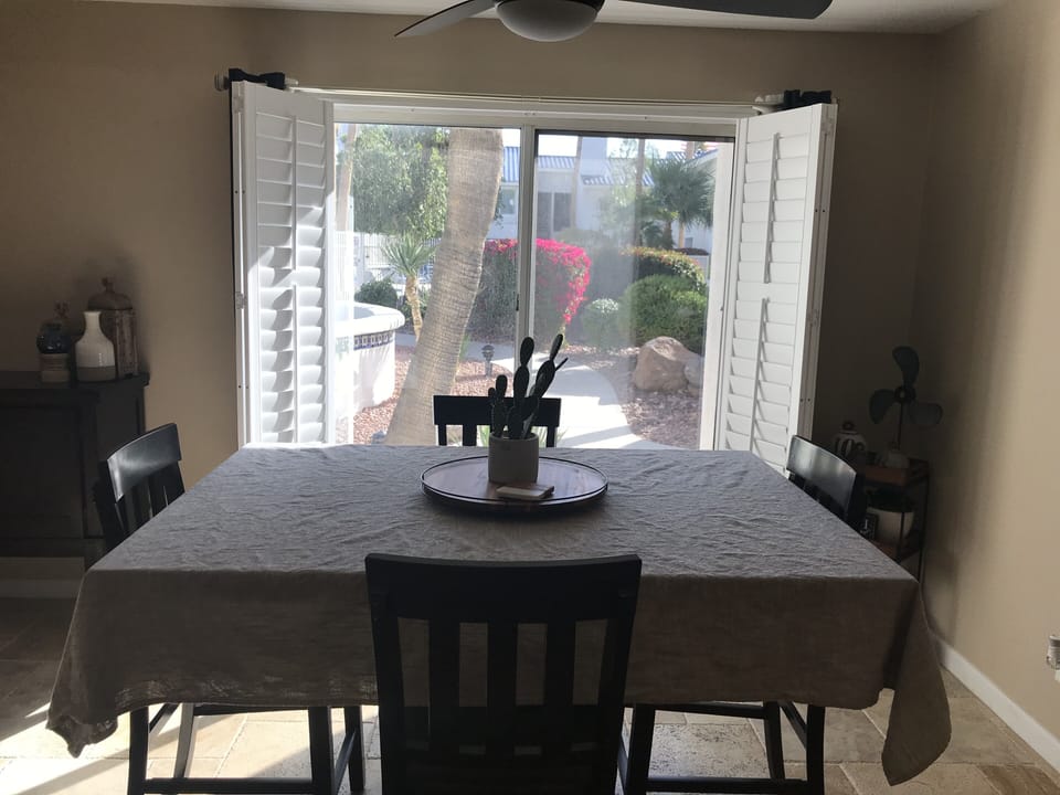 Dining room and kitchen view of walkway to pool 