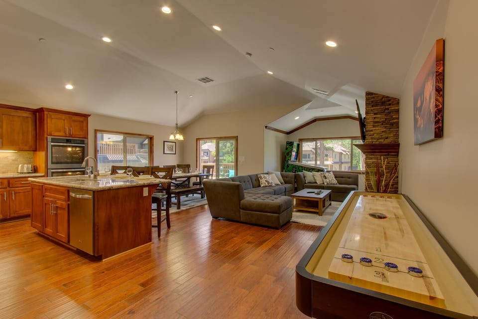- Open concept living with natural light  
- Modern kitchen and dining area combo  
- Shuffleboard game for endless fun