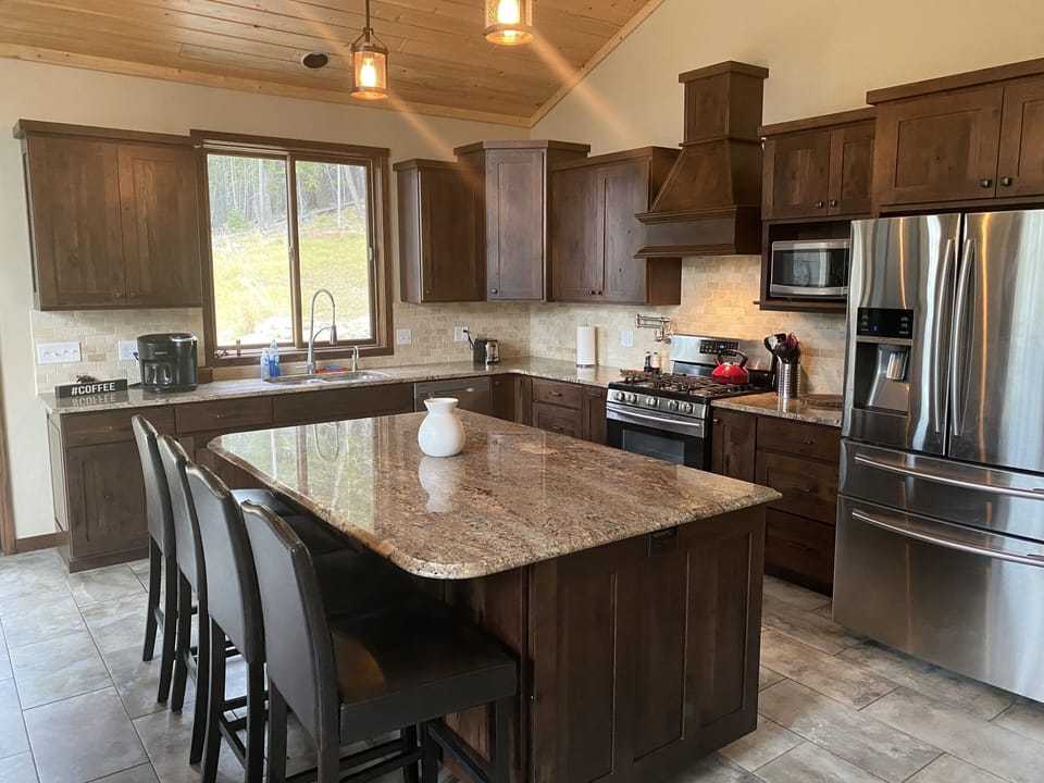 Well appointed Kitchen with large island and bar stools. 