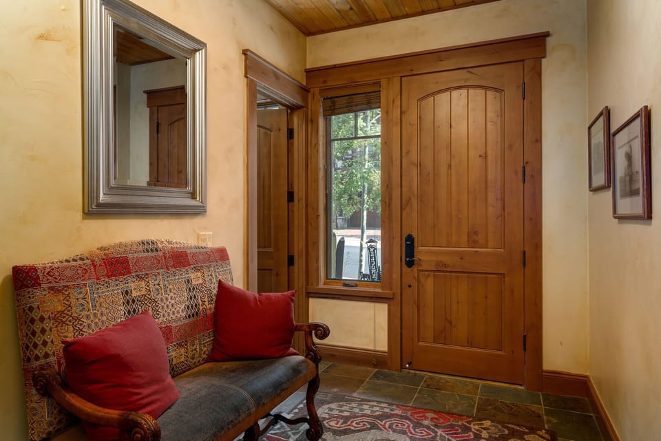 Entryway with very large mud room/gear closet to the left.