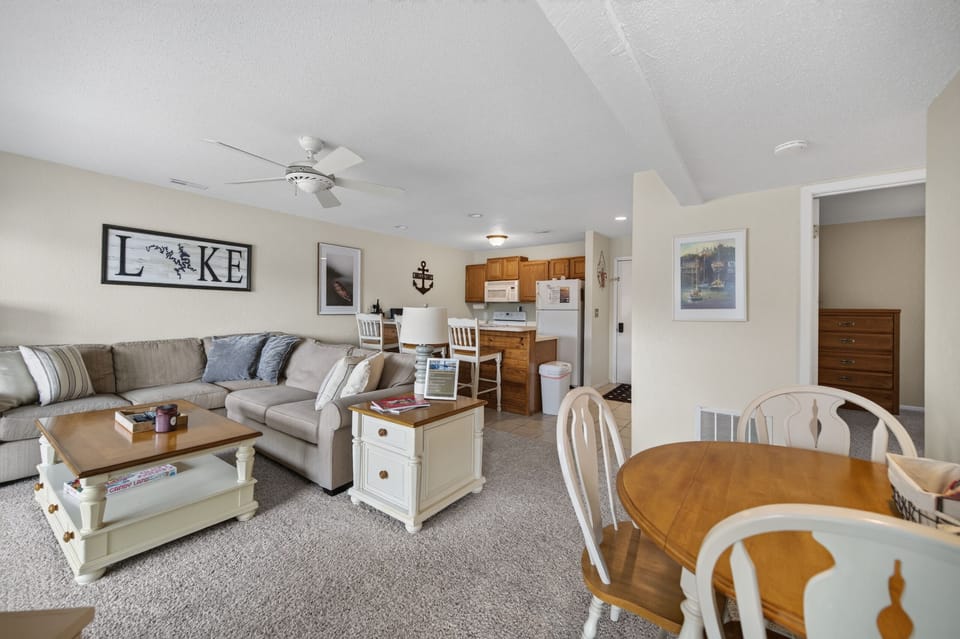 Settle into this inviting open-concept space where your living and dining areas flow seamlessly together. Relax on the plush sectional, gather around the dining table, and enjoy the comfort of your home-away-from-home.