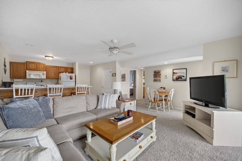 Sink into the plush sectional and unwind in your open-concept living space, where the kitchen, dining, and lounge flow together—ideal for togetherness and relaxation.