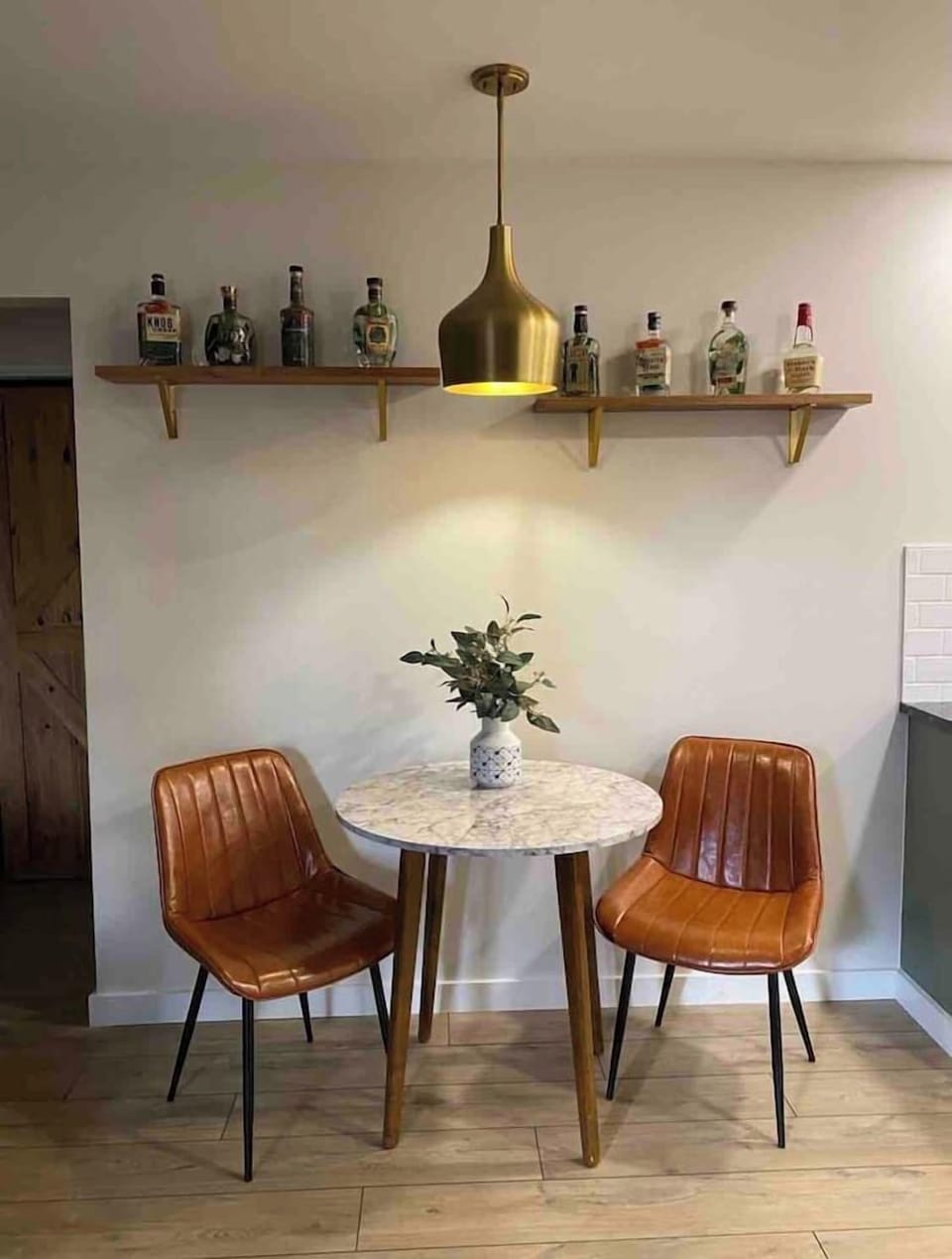 Whiskey bottles displayed above for a fun accent wall