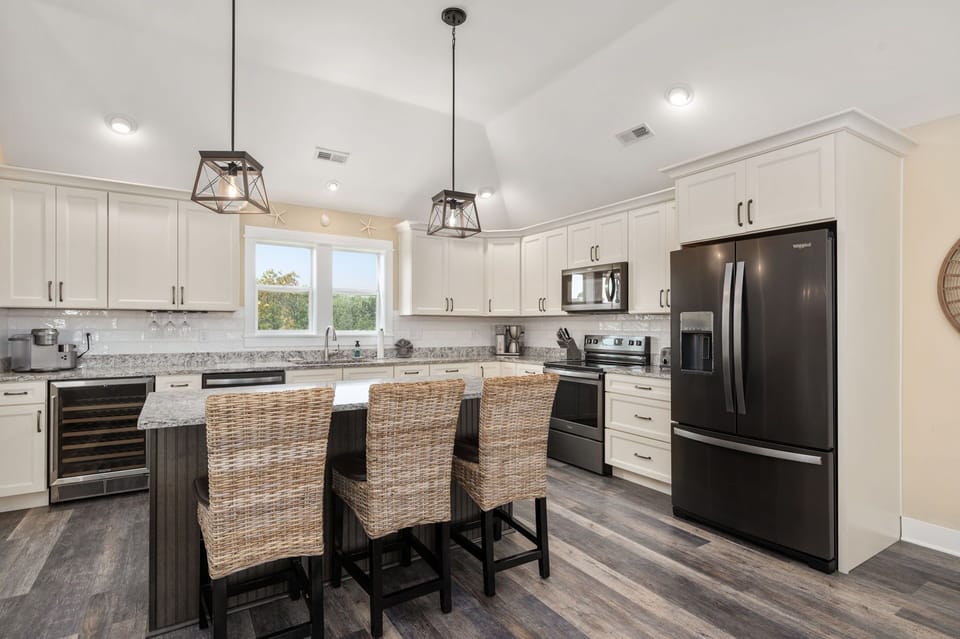 A bright and airy kitchen and sitting area in a refreshing white-themed design.