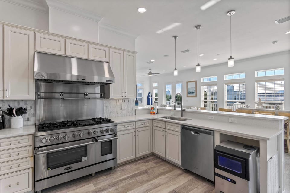 Modern kitchen w/ stainless appliances, ample counters, and clean coastal style.