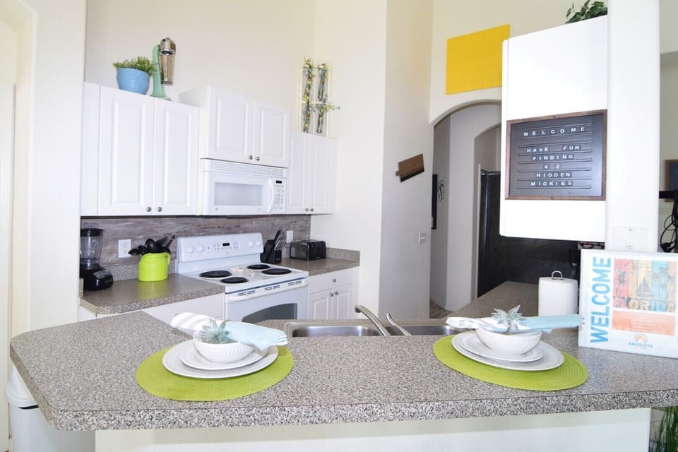 Fully equipped kitchen with breakfast bar and stools