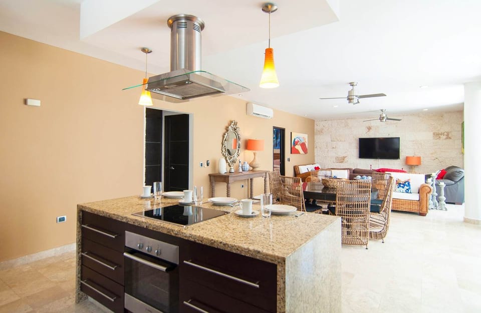 Island features an electric cooktop, oven, & breakfast bar.