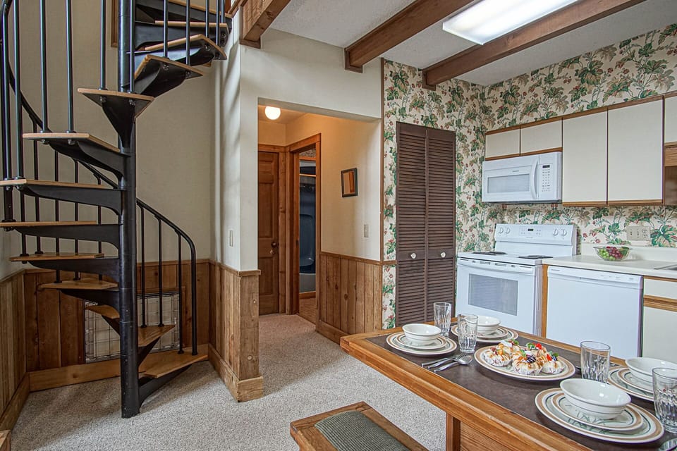 Spiral stair case leading up to the sleeping area in the loft. Mini kitchen and dining area.