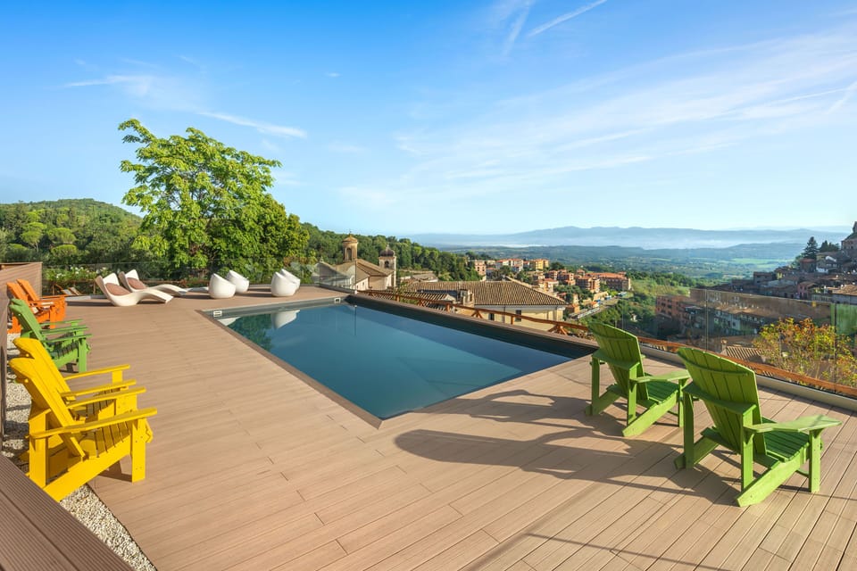 Sparkling seasonal rooftop pool overlooking the charming rooftops of Soriano Nel Cimino.