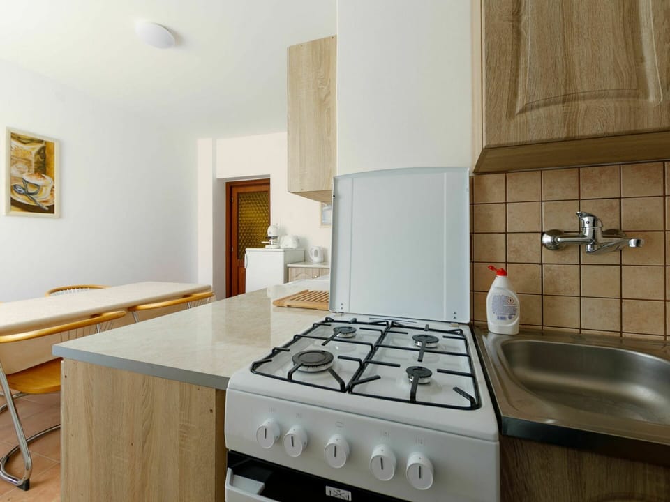 Cabinetry, Furniture, Kitchen Stove, Gas Stove, Cooktop, Countertop, Kitchen Appliance, Kitchen, Wood, Sink