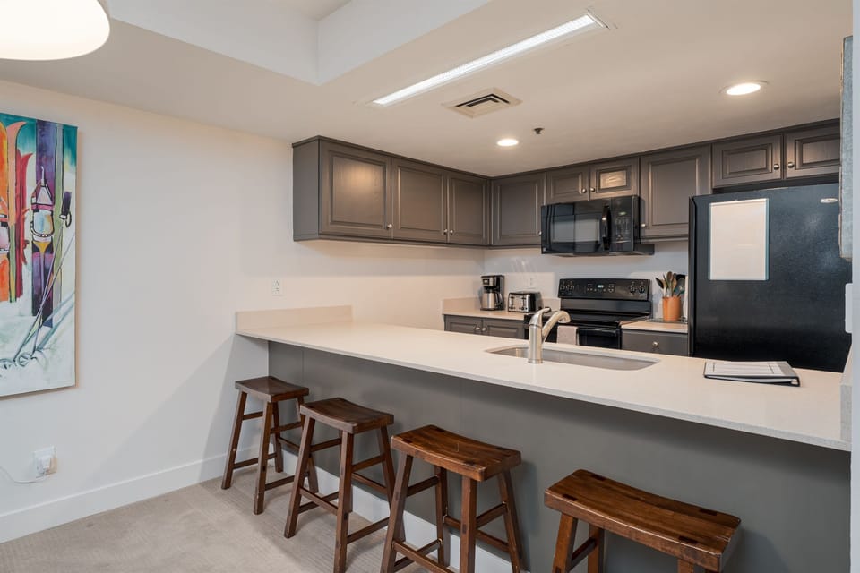 Bar seating between kitchen & dining area.