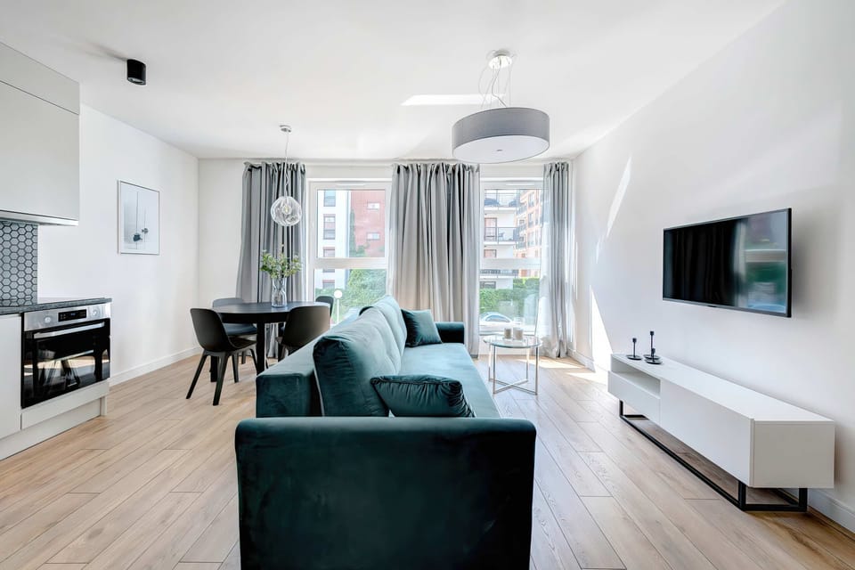 The living room from another perspective, emphasizing the spaciousness and the placement of the furniture around the TV.