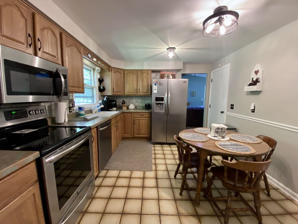 Fully equipped kitchen with newer stainless steel appliances. 