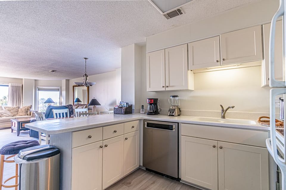 The kitchen is fully stocked with new stainless steel appliances.