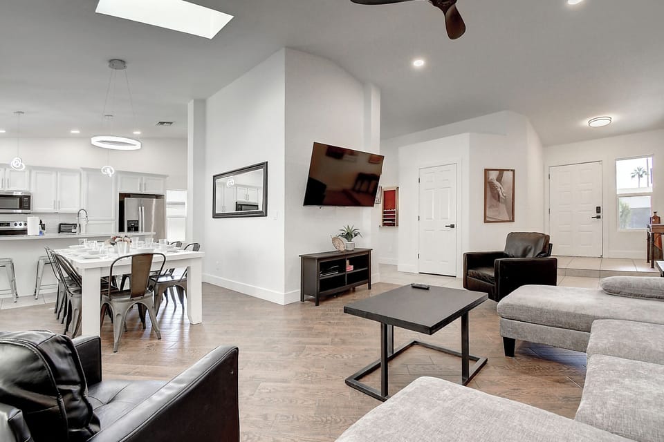Modern great room design with vaulted ceilings, billiards, fireplace and 2 tv's.