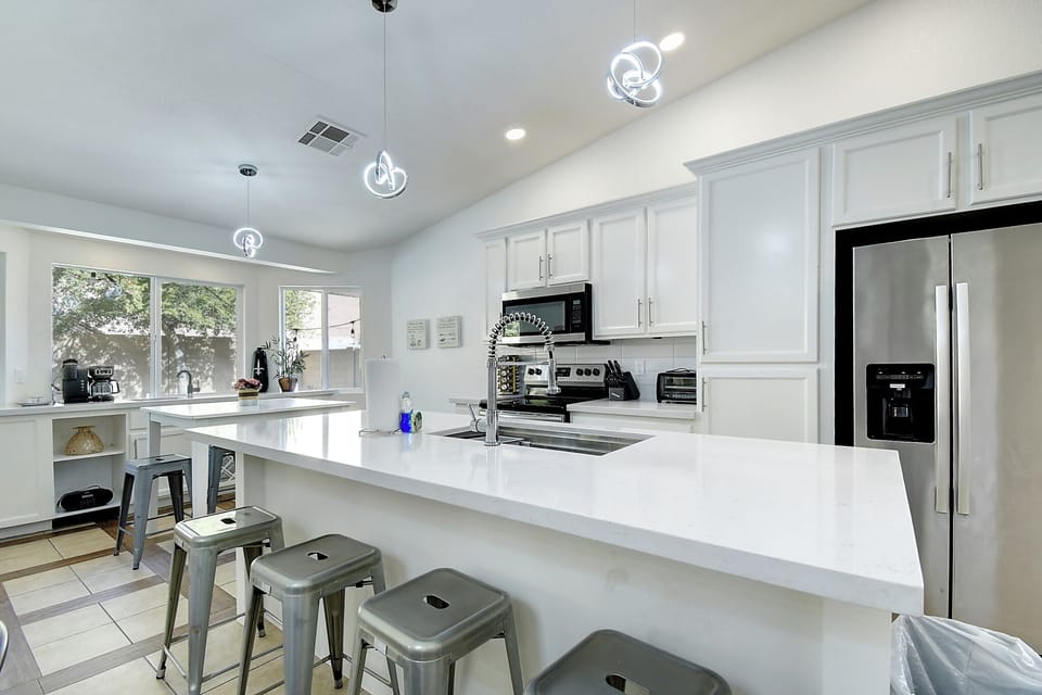 Modern kitchen with seating for 16 inside and another 12 under the patio.