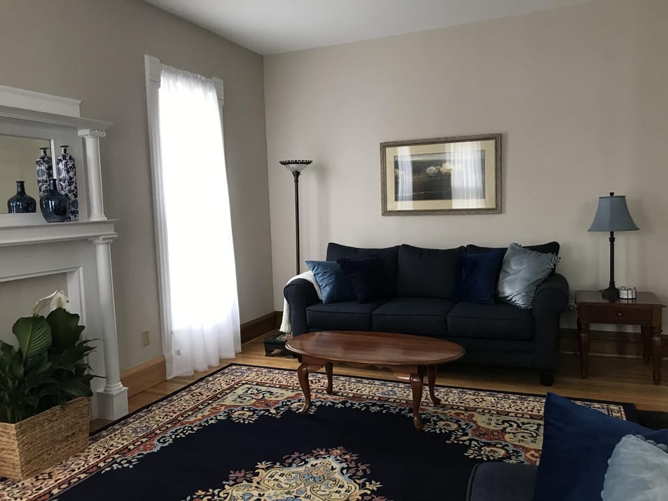 Living room with sofa, loveseat and two comfortable chairs.