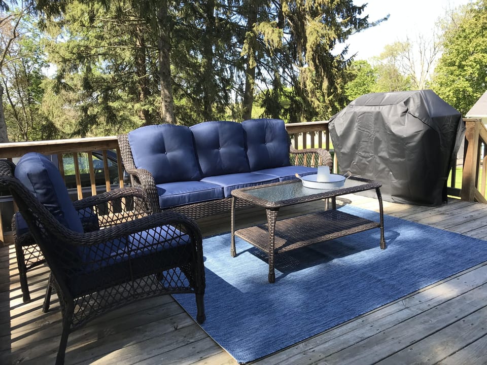 Comfortable seating and barbeque grill on the back deck.